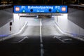 Underground car park entrance with german inscriptions in Luzern. Night view, illuminated by lights. Street signs on the ground Royalty Free Stock Photo