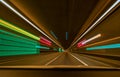 Underground car tunnel with light trails and leading lines. Royalty Free Stock Photo