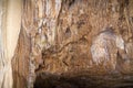 underground cave with many stalactites and stalagmites of different shapes, speleology
