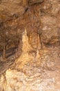 underground cave with many stalactites and stalagmites of different shapes, speleology