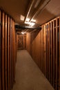 Underground communal cellar corridor artificial illumination wooden dividing doors