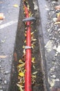 Underground electrical red cable duct in trench at construction building site