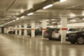 Underground parking lot with row of cars in a modern building. Blurred image Royalty Free Stock Photo