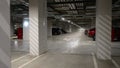 Underground parking under a modern apartment in a residential complex, parked cars, no one, plenty of free parking space