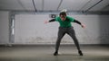 Underground parking. A young deft soccer man training football tricks. Balancing the ball on his body