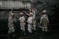 Underground Platinum miners fitting a ventilation pipe