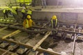 Underground subway tunnel workers pouring concrete