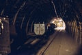 Underground train in black coal mine tunnel Royalty Free Stock Photo