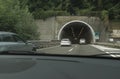 Underground tunnel in the city with cars driving. City infrastructure. Highway through the mountains across. Transportation, trave