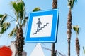 Underground walkway street sign with blue sky and palm trees in background. Pedestrian tunnel signpost with vegetation Royalty Free Stock Photo