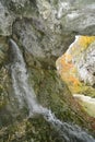 Underground water gushing out of mountain wall at Royalty Free Stock Photo