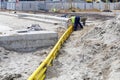 Underground yellow plastic pipes in the sand Royalty Free Stock Photo