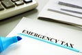 Underlined Emergency tax with papers.