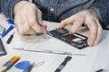 Undermining the mobile phone cover with a special tool. A service employee of mobile phones repairs the phone. Royalty Free Stock Photo