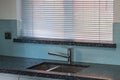 Undermounted stainless steel sink with solid surface worktop.