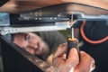 Man using a small screwdriver in a confined space