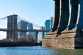 Base of the Manhattan Bridge along the East River with the Lower Manhattan Skyline and Brooklyn Bridge in New York City Royalty Free Stock Photo