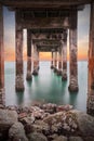 Underneath the pylons of a long jetty pier beach