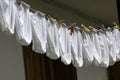 Underpants. The same white underpants hangs outside on a balcony after laundry. Identical underwear becomes dry outdoor