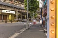 Underpass with metal pillar and neon signs at the west entrance of Kanda Station on the Yamanote Line. The street extends over 300