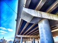 Underpass Structure Showing Concrete Beams and Support Columns. Underneath a highway overpass with visible beams and