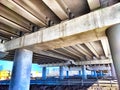 Underpass Structure Showing Concrete Beams and Support Columns. Underneath a highway overpass with visible beams and