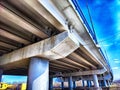 Underpass Structure Showing Concrete Beams and Support Columns. Underneath a highway overpass with visible beams and