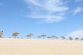 Undershot of a beach with many gazebos the sky in the background Royalty Free Stock Photo