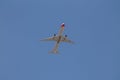 Underside view of a commercial airliner flying