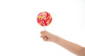 Understanding role sugar young diets. Hand of kid child holds colorful lollipop isolated white background. Children have Royalty Free Stock Photo