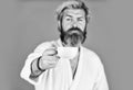 Understanding Your Daily Rhythms. Man with beard in bathrobe enjoy morning coffee. Guy in domestic clothes hold coffee