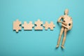 Understood, problems and depression, puzzles in hands of wooden figure Royalty Free Stock Photo