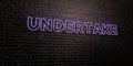 UNDERTAKE -Realistic Neon Sign on Brick Wall background - 3D rendered royalty free stock image Royalty Free Stock Photo