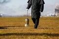 Undertaker carrying an urn with ashes of cremated human Royalty Free Stock Photo