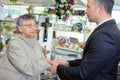 Undertaker shaking hand elderly lady