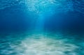 Underwater backgraund, surfface and seabed with sand bottom Royalty Free Stock Photo