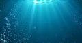 Underwater background with water bubbles, undersea light rays shine