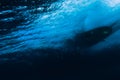 Underwater barrel wave in tropical ocean and surfboard