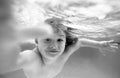 Underwater boy in the swimming pool. Cute kid boy swimming in pool under water. Royalty Free Stock Photo