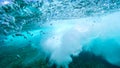 UNDERWATER: Bubbles rise from the depths after barrel wave rushes over camera Royalty Free Stock Photo