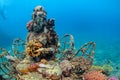 Underwater Buddha statue with diving snorkeler on the background