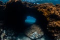 Underwater cave and reef with corals in blue ocean Royalty Free Stock Photo