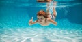 Underwater child swim in water swimming pool. Summer activity and healthy kids lifestyle. Summer vacation with children Royalty Free Stock Photo