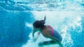 Underwater closeup image of 10 years old girl swimming and diving in the swimming pool Royalty Free Stock Photo