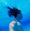 Underwater diving. Relaxation, sport, sunlight, travel, healthy lifestyle. Guy is diving under water. Summer vacation concept.