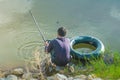 Underwater hunter diver man with speargun preparing to dive on a life ring looks under the water in search of fish