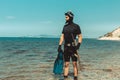Underwater Hunter Man In Diving Suit With Equipment Goes To Sea In Summer Outdoors