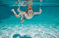 Underwater kid swim under water. Child boy swimming and diving underwater in pool. Summer family summer vacation with Royalty Free Stock Photo