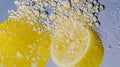 Underwater lemon slice in soda water or lemonade with bubbles