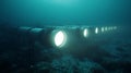 Underwater lights glowing in the deep sea exploration with ocean pipeline technology system view design Royalty Free Stock Photo